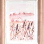 Aquarelle paysage fantastique représentant un champs de blé dans les tonalités de roses et son encadrement réalisée par Christelle Lachambre artiste-peintre
